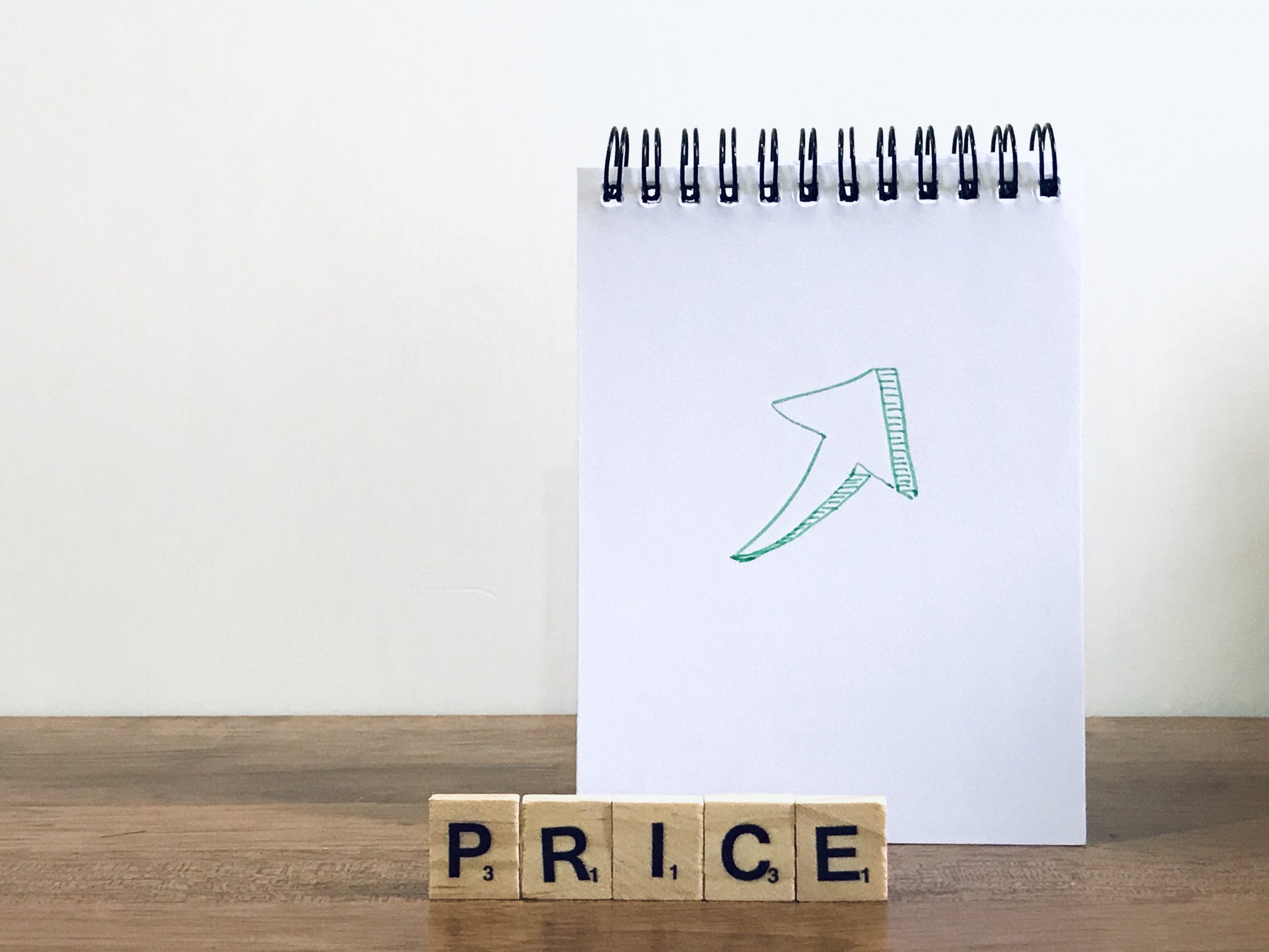 Note pad with an up arrow and the words price